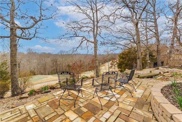 view of patio featuring a view of trees