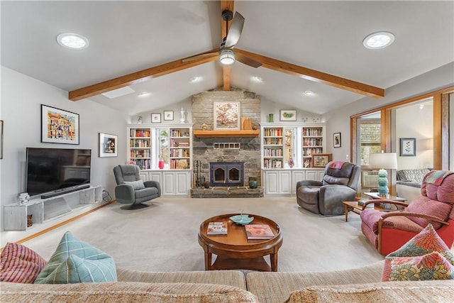 carpeted living room featuring a stone fireplace, lofted ceiling with beams, and ceiling fan