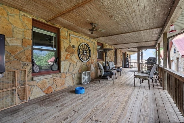 wooden deck featuring ceiling fan