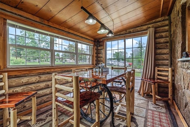 dining room featuring wooden ceiling, a wealth of natural light, log walls, and lofted ceiling