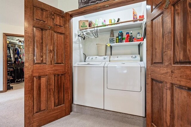 clothes washing area featuring washer and dryer, carpet, and laundry area
