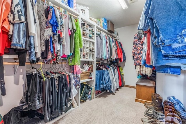 walk in closet with carpet