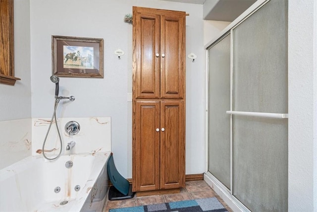 bathroom featuring a shower stall, tile patterned flooring, and a jetted tub