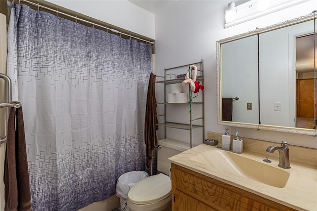 bathroom with curtained shower, toilet, and vanity