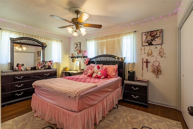 bedroom featuring a ceiling fan, wood finished floors, and a closet