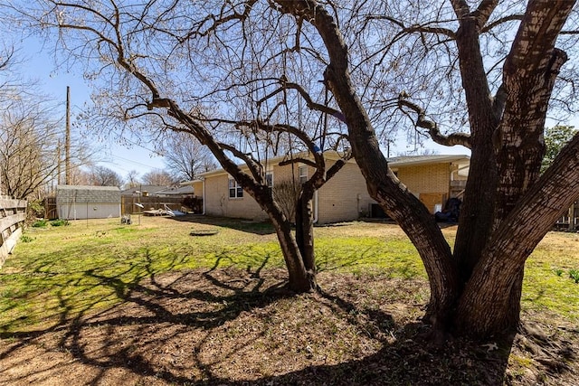 view of yard with an outdoor structure and fence