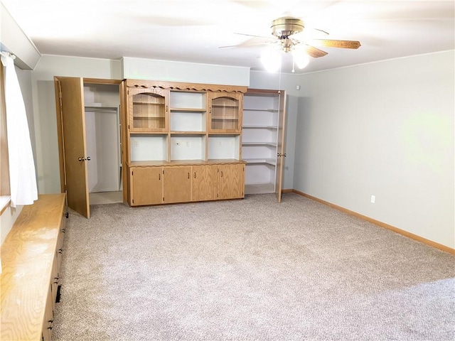 unfurnished bedroom with baseboards, ceiling fan, and light carpet