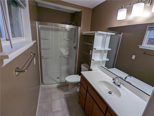 full bathroom featuring tile patterned flooring, a stall shower, toilet, and vanity