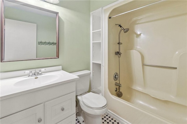 bathroom featuring toilet, vanity, and bathtub / shower combination