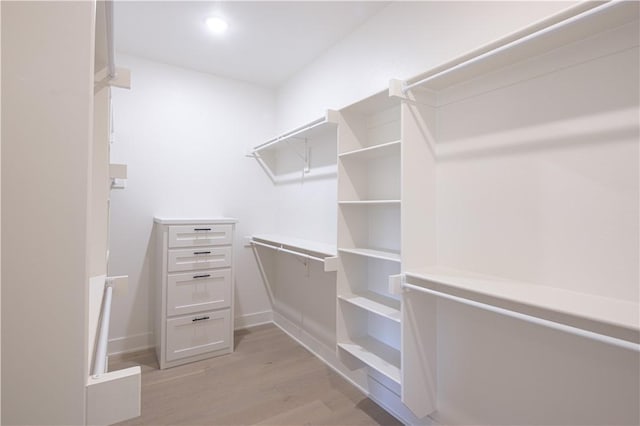 walk in closet featuring light wood-style flooring