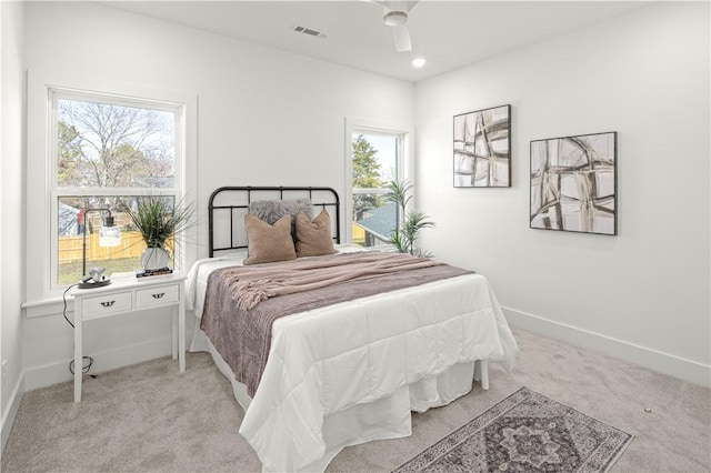 bedroom with visible vents, baseboards, and light colored carpet