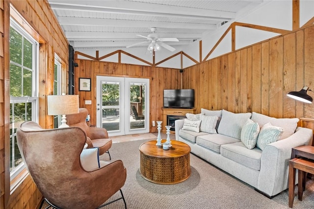 21574 Indian Creek Dr, Garfield, AR 72732 - living area with lofted ceiling with beams, wooden walls, and ceiling fan