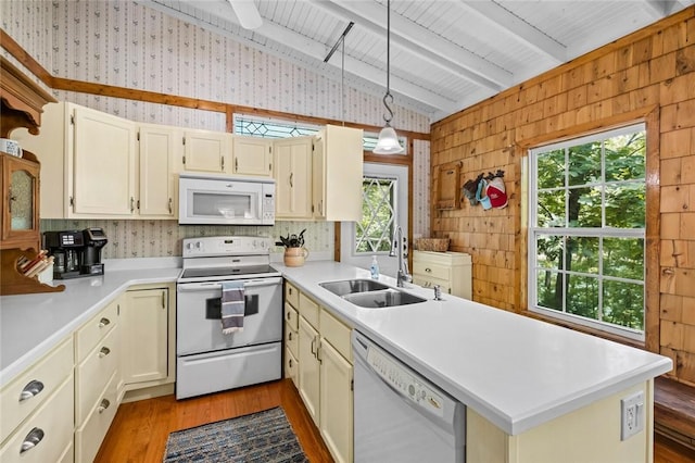 21574 Indian Creek Dr, Garfield, AR 72732 - kitchen featuring white appliances, a peninsula, vaulted ceiling with beams, a sink, and wood walls