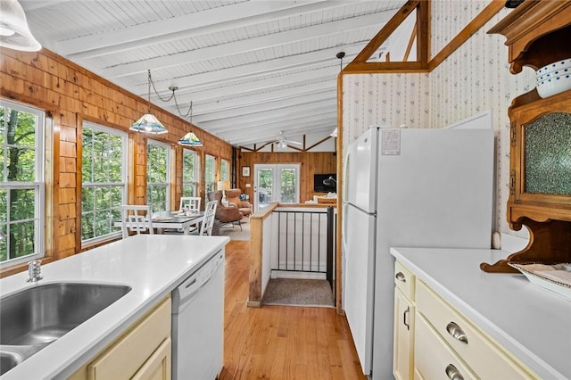 21574 Indian Creek Dr, Garfield, AR 72732 - kitchen with wood walls, white appliances, lofted ceiling with beams, and a sink