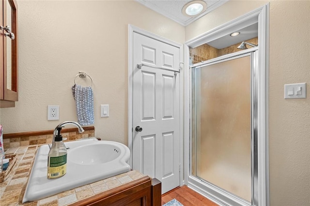 21574 Indian Creek Dr, Garfield, AR 72732 - full bathroom featuring ornamental molding, a textured wall, a stall shower, and a sink