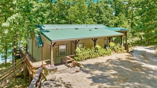 21574 Indian Creek Dr, Garfield, AR 72732 - view of front facade featuring a porch, driveway, and metal roof