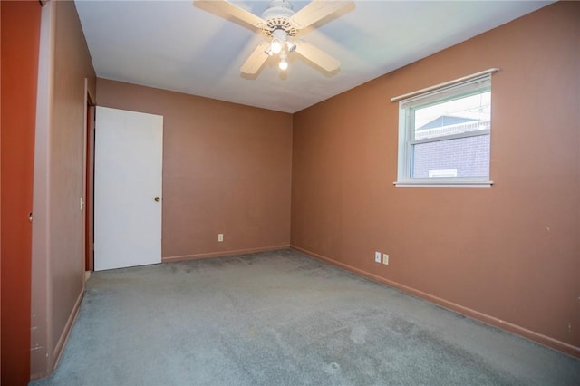 unfurnished bedroom featuring carpet flooring, a ceiling fan, and baseboards