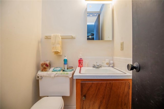 half bathroom featuring toilet and vanity