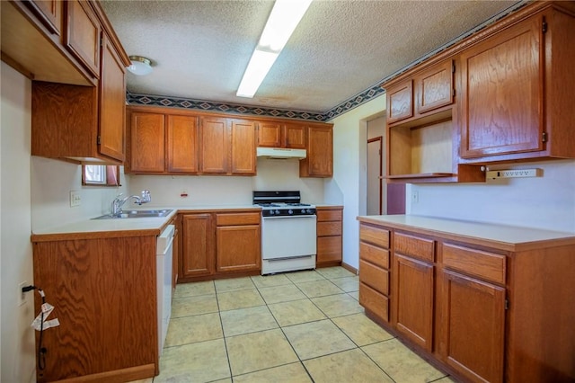 kitchen with a sink, white appliances, under cabinet range hood, and brown cabinetry