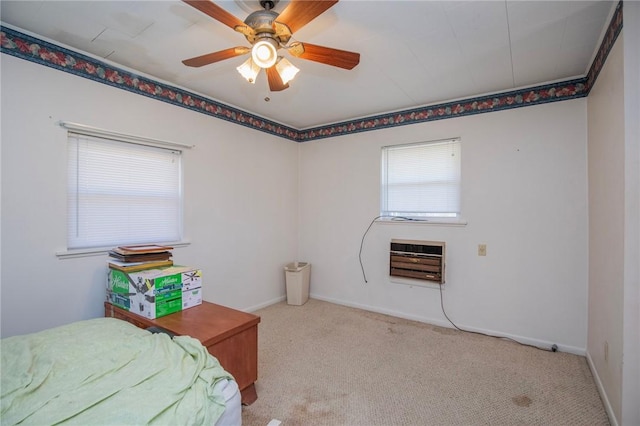 bedroom featuring heating unit, light colored carpet, a ceiling fan, and baseboards