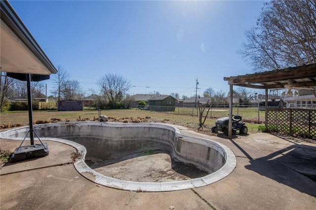 view of swimming pool with a lawn, a patio, and fence