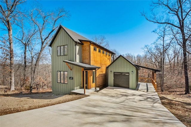 10 Reading Ln, Bella Vista, AR 72714 - view of front of property with driveway, an attached garage, and board and batten siding