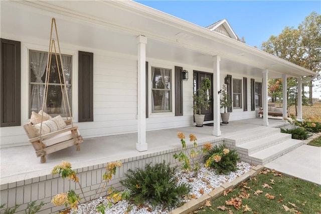entrance to property featuring covered porch
