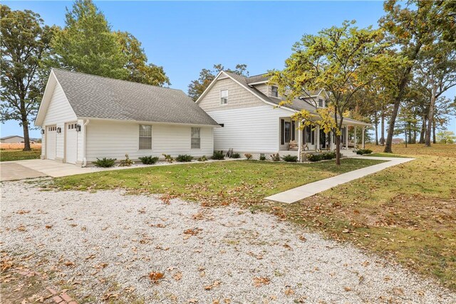 view of front of property featuring concrete driveway, an attached garage, and a front lawn