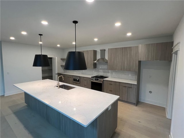 123 S Paddock Loop, Fayetteville, AR 72701 - kitchen with a sink, stainless steel range with gas stovetop, wall chimney range hood, modern cabinets, and an island with sink