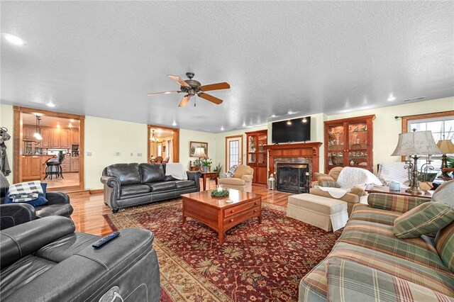 2428 Winn Mountain Loop, Mountainburg, AR 72946 - living room with recessed lighting, a textured ceiling, light wood-style floors, and ceiling fan