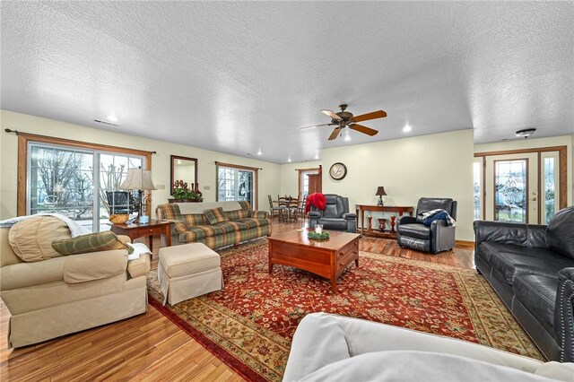 2428 Winn Mountain Loop, Mountainburg, AR 72946 - living room with recessed lighting, wood finished floors, a textured ceiling, and ceiling fan
