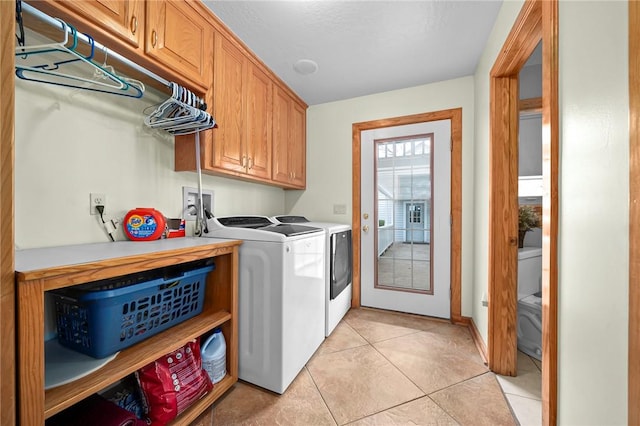 2428 Winn Mountain Loop, Mountainburg, AR 72946 - clothes washing area with cabinet space, washing machine and dryer, and light tile patterned flooring
