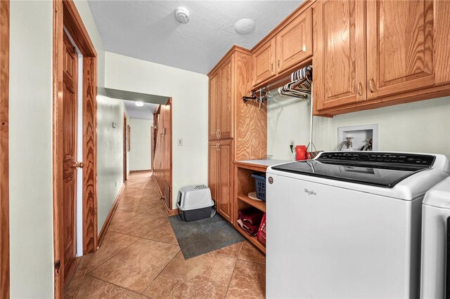 2428 Winn Mountain Loop, Mountainburg, AR 72946 - laundry area featuring cabinet space, light tile patterned flooring, and washer and clothes dryer
