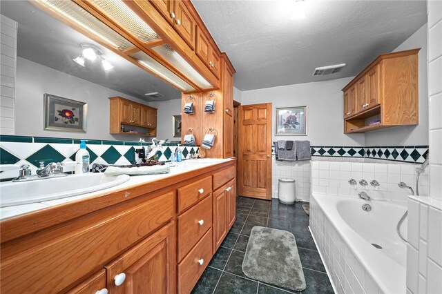 2428 Winn Mountain Loop, Mountainburg, AR 72946 - full bathroom featuring tile patterned floors, a sink, a bath, tile walls, and double vanity