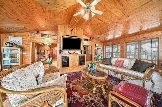 2428 Winn Mountain Loop, Mountainburg, AR 72946 - living room with a ceiling fan, wood walls, wood ceiling, and vaulted ceiling with beams