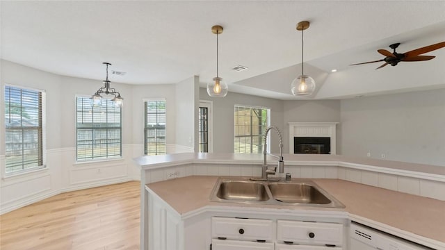 108 Birch St, Centerton, AR 72719 - kitchen featuring a sink, dishwasher, light wood finished floors, light countertops, and white cabinets