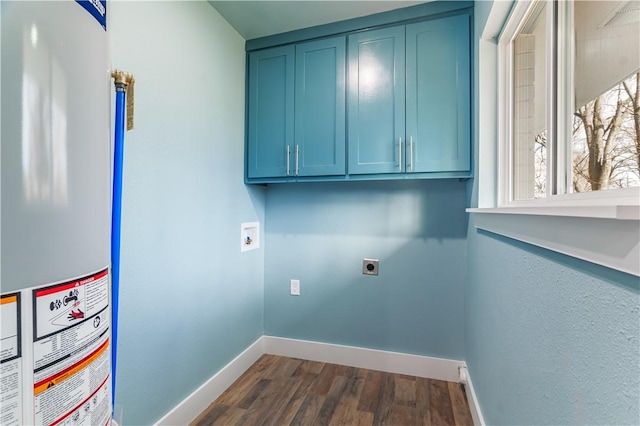 washroom with water heater, baseboards, hookup for an electric dryer, cabinet space, and dark wood-style floors