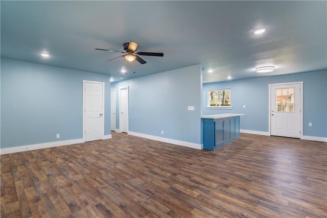 empty room with a ceiling fan, dark wood finished floors, baseboards, and recessed lighting