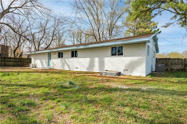 back of house featuring brick siding, crawl space, and cooling unit
