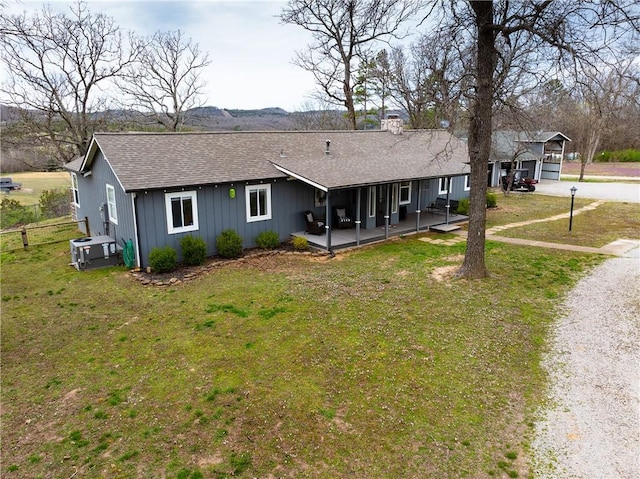 82 County Road 327, Berryville, AR 72616 - rear view of property with roof with shingles, driveway, a yard, a chimney, and board and batten siding