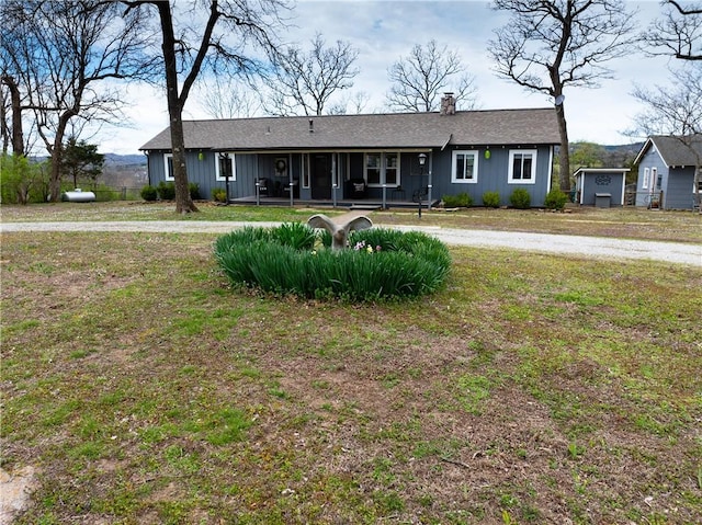 82 County Road 327, Berryville, AR 72616 - single story home featuring covered porch, a chimney, a shingled roof, and board and batten siding