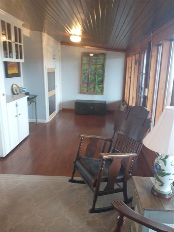 82 County Road 327, Berryville, AR 72616 - living area with wooden ceiling, wood finished floors, and baseboards