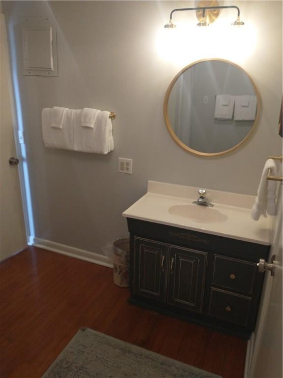 82 County Road 327, Berryville, AR 72616 - bathroom featuring vanity, wood finished floors, and baseboards