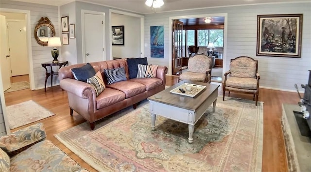 82 County Road 327, Berryville, AR 72616 - living area with wood finished floors, baseboards, wood walls, and ornamental molding