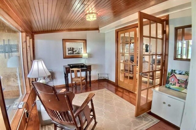 82 County Road 327, Berryville, AR 72616 - living area featuring french doors, wood finished floors, baseboards, and ornamental molding