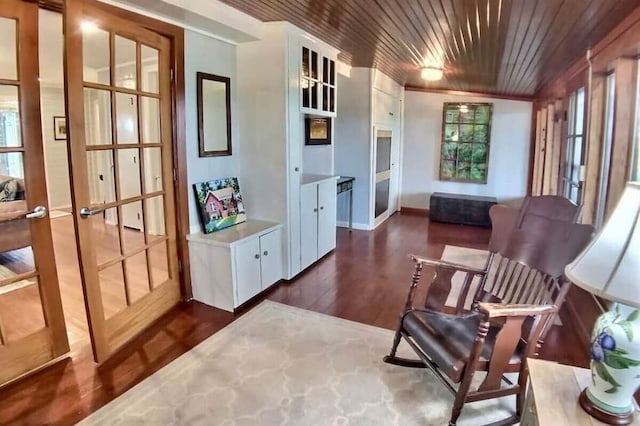 82 County Road 327, Berryville, AR 72616 - living area featuring plenty of natural light, wood ceiling, dark wood-type flooring, and baseboards