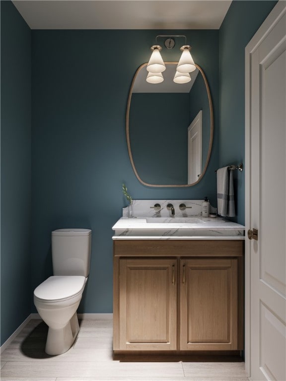 423 SE B St, Bentonville, AR 72712 - bathroom with toilet, vanity, and baseboards
