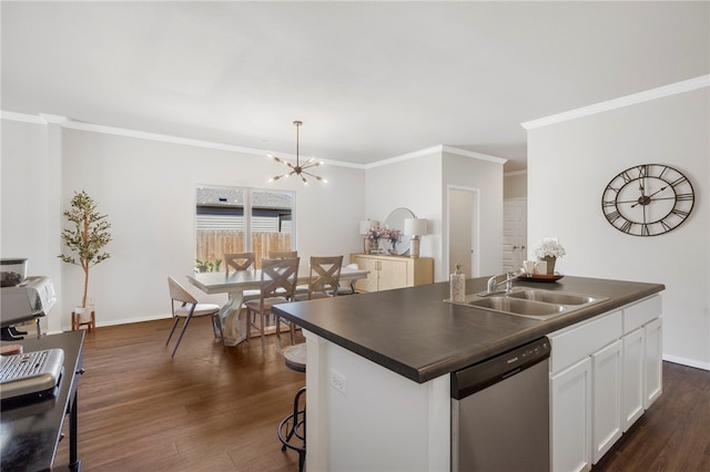 kitchen with dark countertops, a sink, dishwasher, white cabinets, and dark wood-style floors
