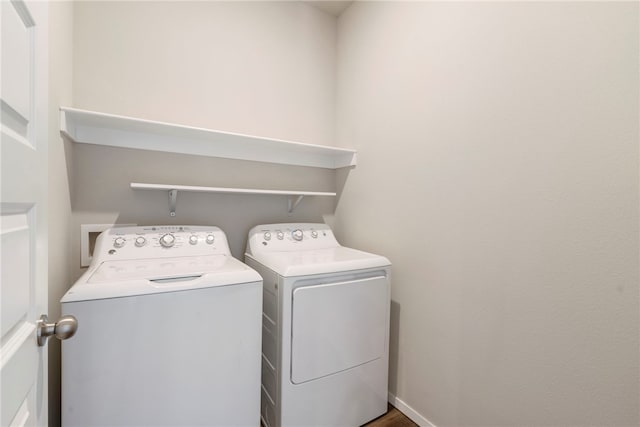 clothes washing area featuring washing machine and clothes dryer and laundry area