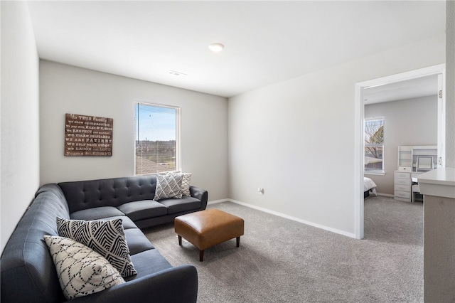 living room with visible vents, baseboards, and carpet flooring